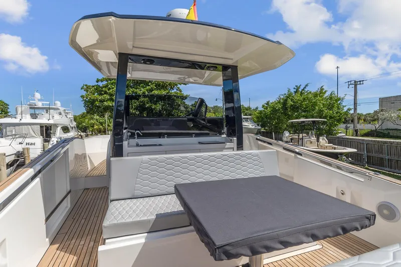  Yacht Photos Pics 2023 Astondoa 377 Coupe Outboard yacht with modern seating and table on deck.