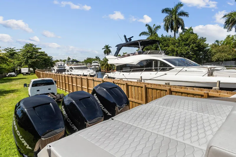  Yacht Photos Pics 2023 Astondoa 377 Coupe Outboard with triple Mercury engines docked near other luxury yachts.