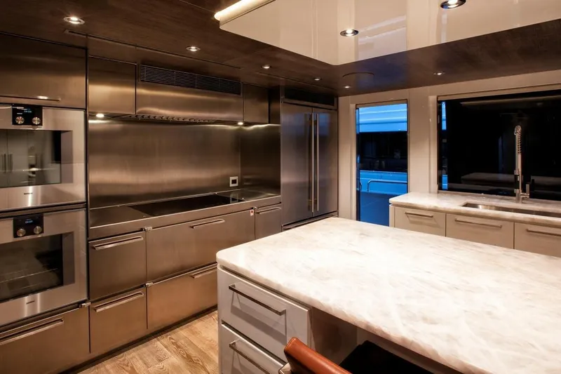 Serenity Yacht Photos Pics Luxurious kitchen in 2018 Westport Raised Pilothouse yacht with modern stainless steel appliances.