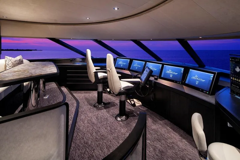 Serenity Yacht Photos Pics Luxurious 2018 Westport Raised Pilothouse interior with panoramic ocean view at sunset.