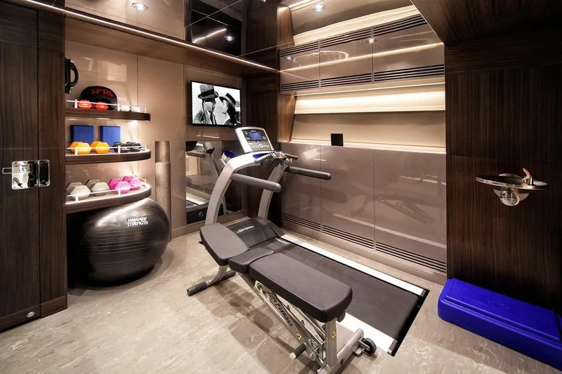 Serenity Yacht Photos Pics Luxurious yacht gym with treadmill, weights, and TV in 2018 Westport Raised Pilothouse.