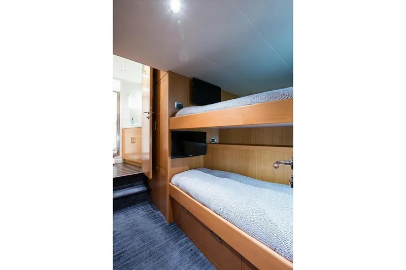 Serenity Yacht Photos Pics Bunk beds in 2018 Westport Raised Pilothouse yacht cabin, featuring modern wood design.