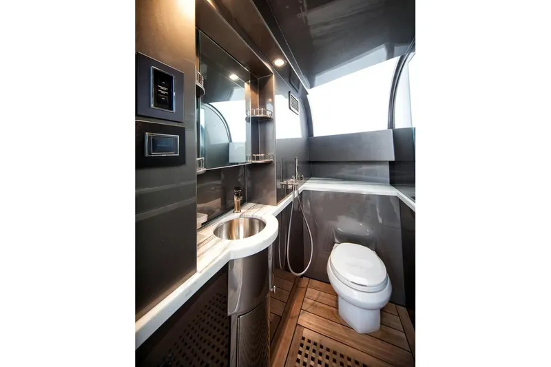Serenity Yacht Photos Pics Luxurious bathroom in 2018 Westport Raised Pilothouse yacht with modern fixtures and wooden flooring.