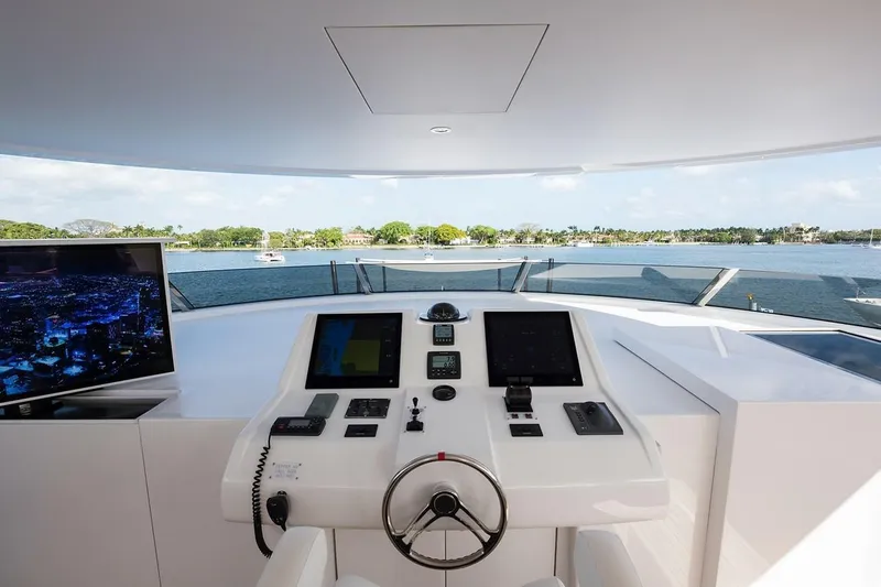 Serenity Yacht Photos Pics 2018 Westport Raised Pilothouse yacht helm with modern controls and scenic water view.