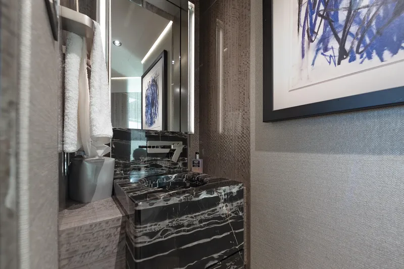 Serenity Yacht Photos Pics Luxurious bathroom in 2018 Westport Raised Pilothouse yacht with marble sink and modern decor.