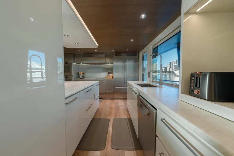 Serenity Yacht Photos Pics Luxurious kitchen interior on 2018 Westport Raised Pilothouse yacht with modern appliances and waterfront view.