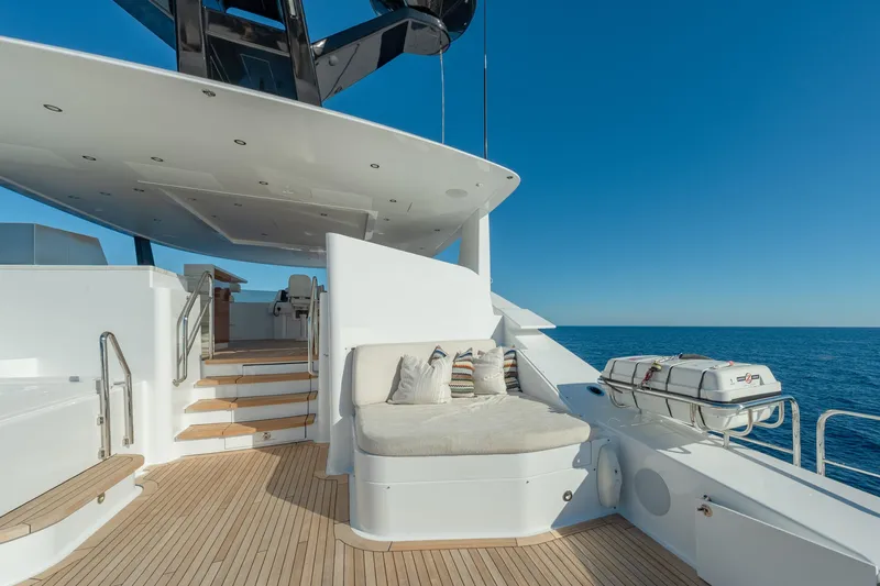 Serenity Yacht Photos Pics Luxurious 2018 Westport Raised Pilothouse yacht deck with seating, ocean view, and clear blue sky.
