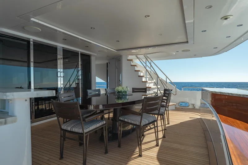 Serenity Yacht Photos Pics Luxurious 2018 Westport Raised Pilothouse yacht deck with elegant dining area and ocean view.