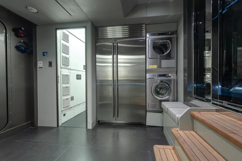 Serenity Yacht Photos Pics Laundry area in 2018 Westport Raised Pilothouse yacht with stainless steel appliances.