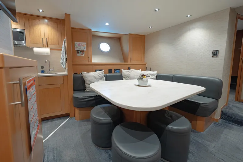 Serenity Yacht Photos Pics Luxurious 2018 Westport Raised Pilothouse yacht interior with modern dining area and kitchenette.
