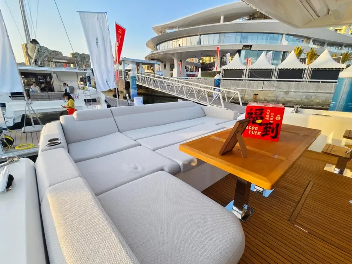  Yacht Photos Pics Luxurious 2022 Prestige 590 yacht with spacious deck and modern seating at a marina.