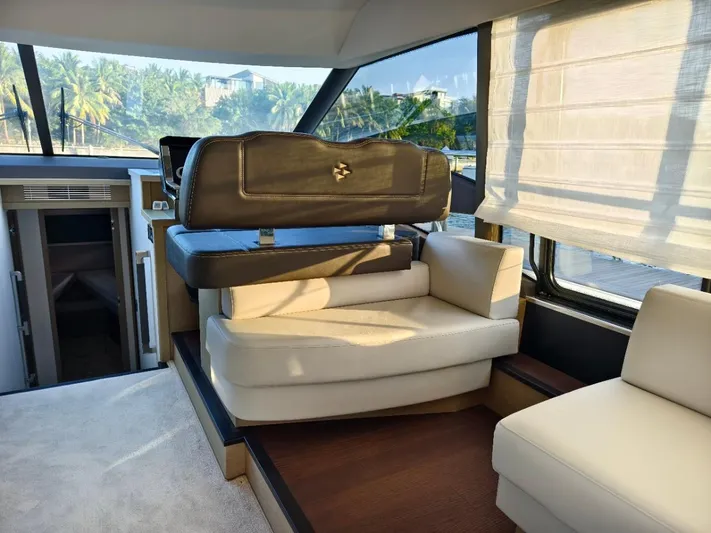  Yacht Photos Pics Luxurious interior of 2022 Prestige 590 yacht with elegant seating and panoramic windows.