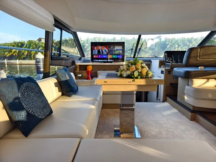  Yacht Photos Pics Luxurious interior of 2022 Prestige 590 yacht with elegant seating and modern entertainment system.