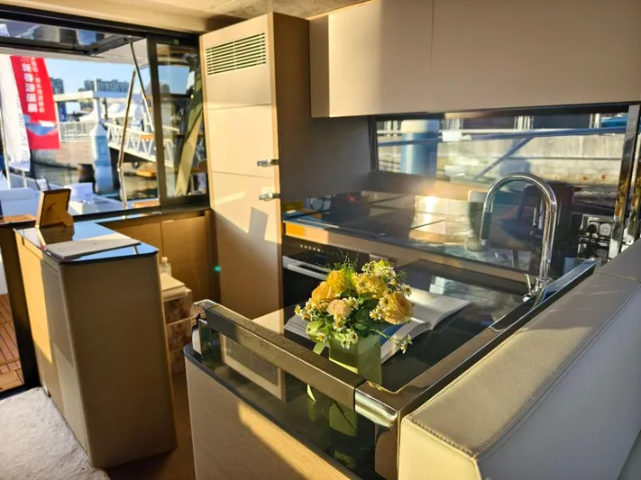  Yacht Photos Pics Luxurious 2022 Prestige 590 yacht kitchen with modern design and elegant floral centerpiece.