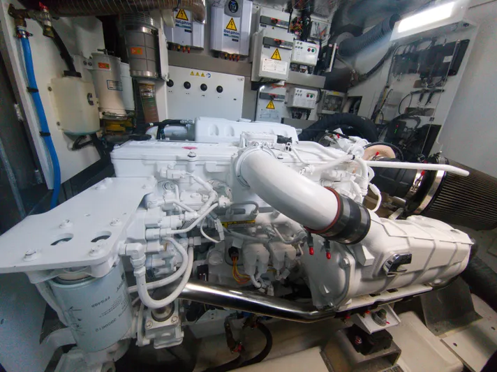  Yacht Photos Pics Engine room of a 2022 Prestige 590 yacht, showcasing complex machinery and components.