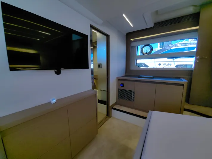  Yacht Photos Pics Luxurious interior of 2022 Prestige 590 yacht with modern furnishings and large window.