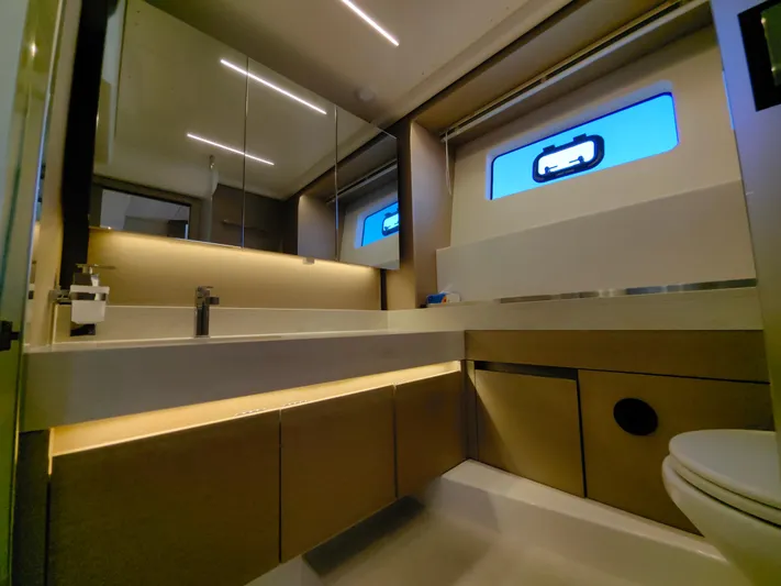  Yacht Photos Pics Luxurious bathroom interior of 2022 Prestige 590 yacht, featuring modern design and ambient lighting.