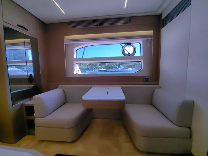  Yacht Photos Pics Luxurious interior of 2022 Prestige 590 yacht with elegant seating and large window view.