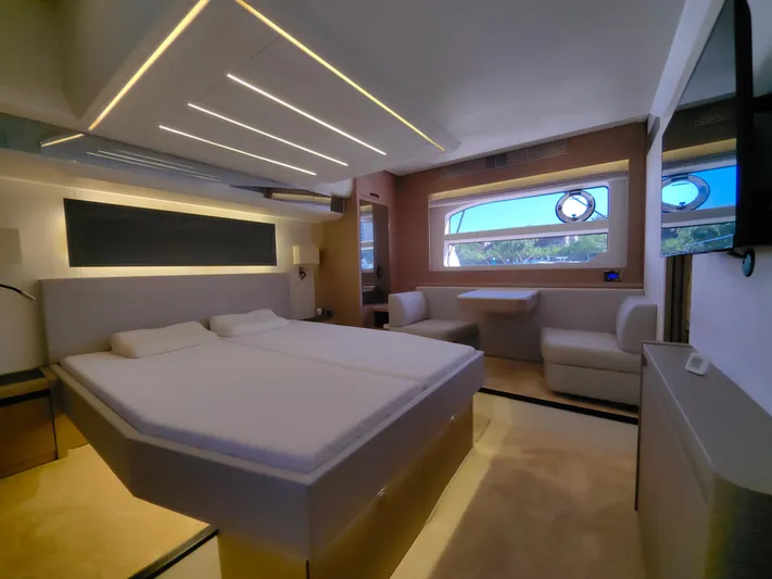  Yacht Photos Pics Luxurious interior of a 2022 Prestige 590 yacht, featuring a spacious bedroom and seating area.