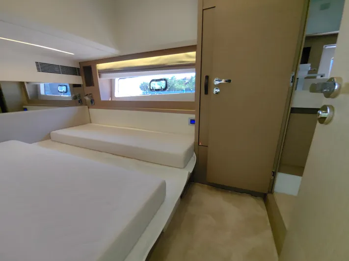  Yacht Photos Pics Luxurious interior of 2022 Prestige 590 yacht cabin with modern design and comfortable bedding.