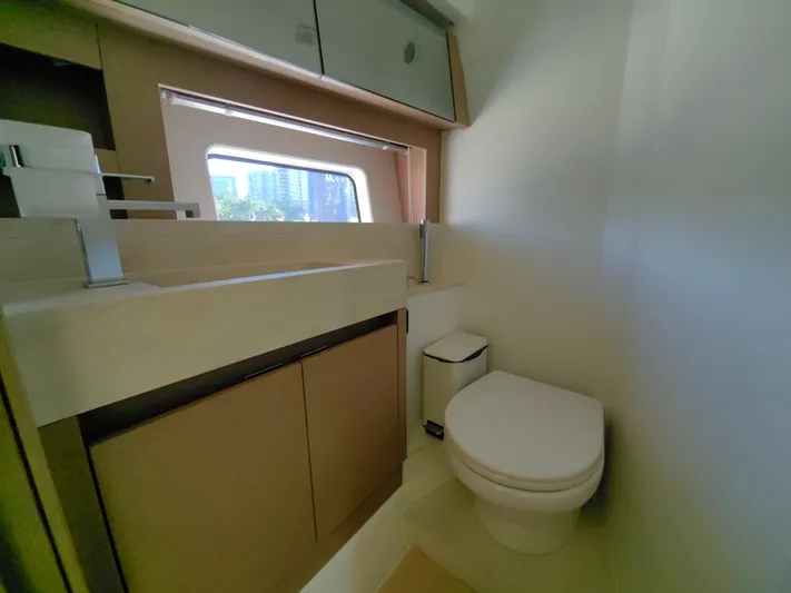  Yacht Photos Pics Modern bathroom interior on 2022 Prestige 590 yacht, featuring sleek fixtures and a window view.