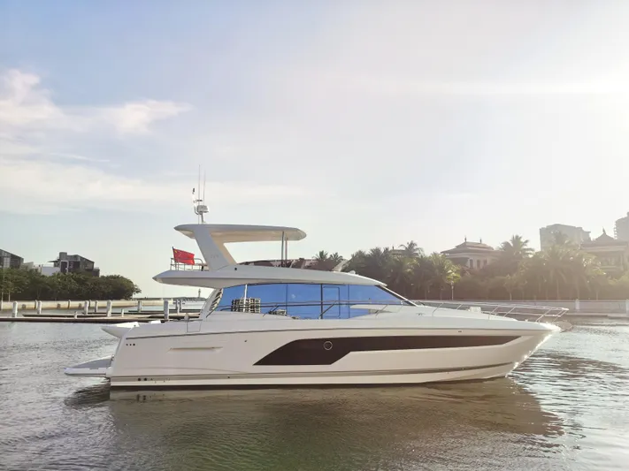  Yacht Photos Pics 2022 Prestige 590 yacht on calm water, with a scenic background.