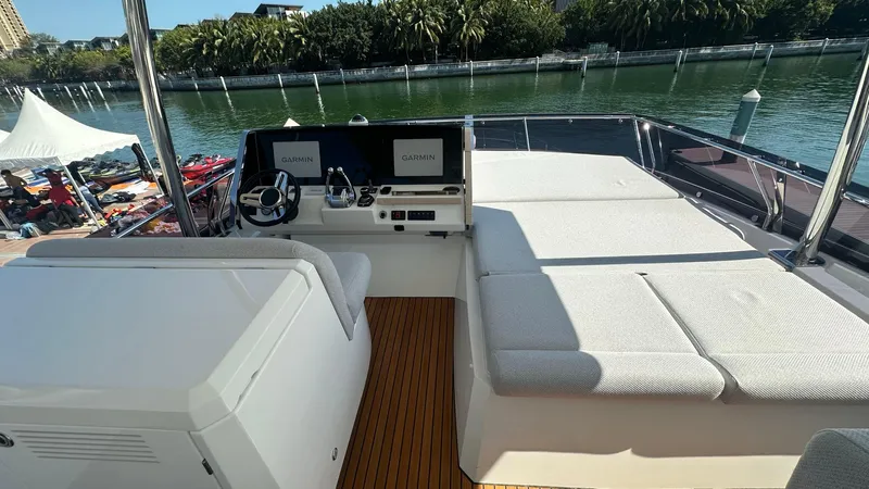  Yacht Photos Pics Prestige 590 yacht interior, 2022 model, featuring a spacious deck with seating and navigation controls.