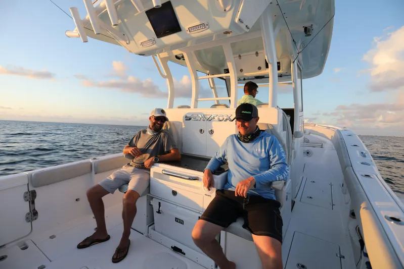 Black Label Marine Group Yacht Photos Pics 2025 Sea Fox 368 Commander Center Console boat with people relaxing on deck.