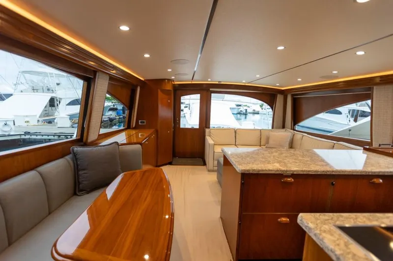 Trailer Trash Yacht Photos Pics Luxurious interior of 2021 Viking 58 Convertible yacht with elegant wood and plush seating.