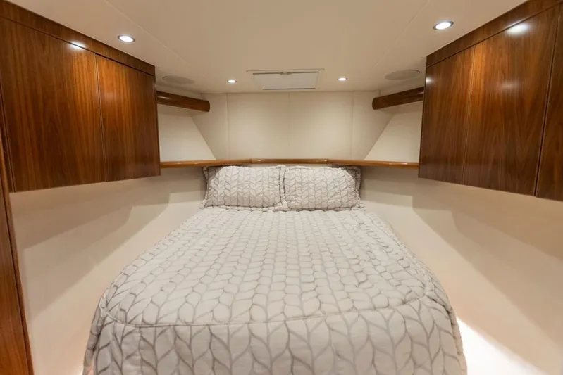 Trailer Trash Yacht Photos Pics Luxurious bedroom interior of 2021 Viking 58 Convertible yacht with elegant wood cabinetry.
