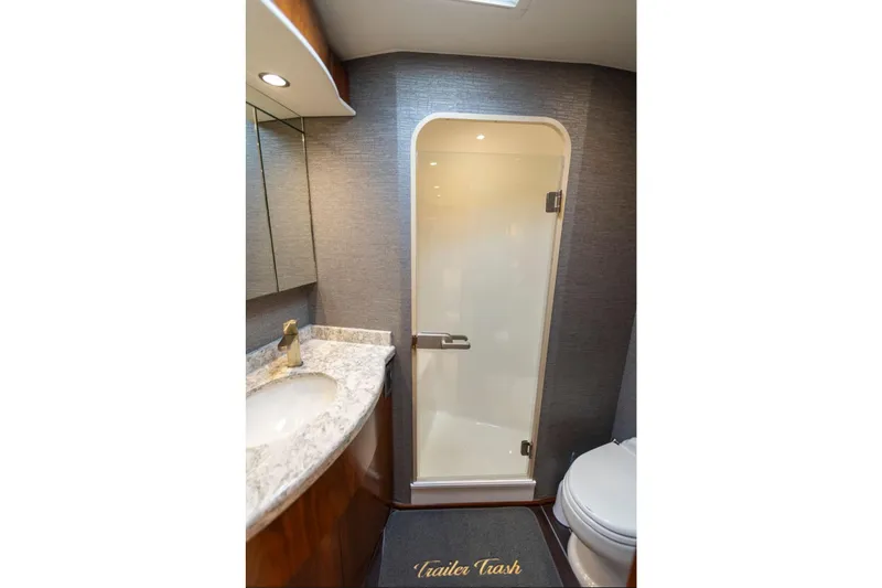 Trailer Trash Yacht Photos Pics Luxurious bathroom in 2021 Viking 58 Convertible yacht with modern fixtures and elegant design.