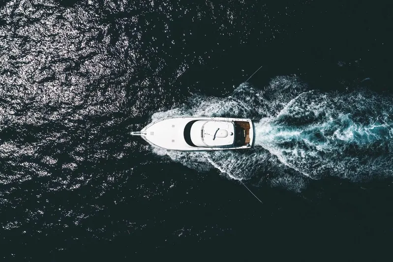 Trailer Trash Yacht Photos Pics Aerial view of 2021 Viking 58 Convertible yacht cruising through ocean waters.