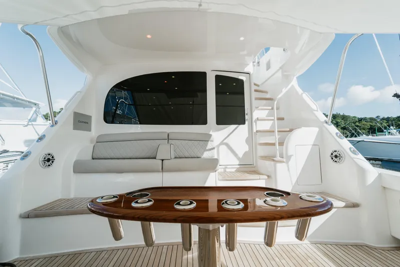 Trailer Trash Yacht Photos Pics Luxurious 2021 Viking 58 Convertible yacht interior with seating and elegant wooden table.