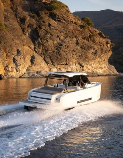  Yacht Photos Pics 2024 De Antonio Yachts D36 OPEN cruising near rocky coastline.