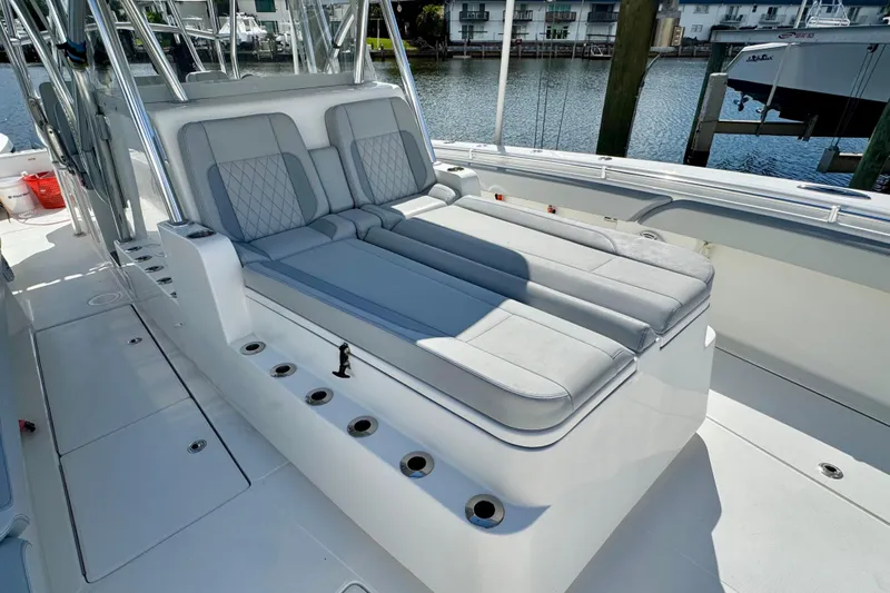 Trade In-- Bring All Offers & Trades Yacht Photos Pics 2021 SeaHunter 41 CTS boat with luxurious seating and rod holders, docked by the water.