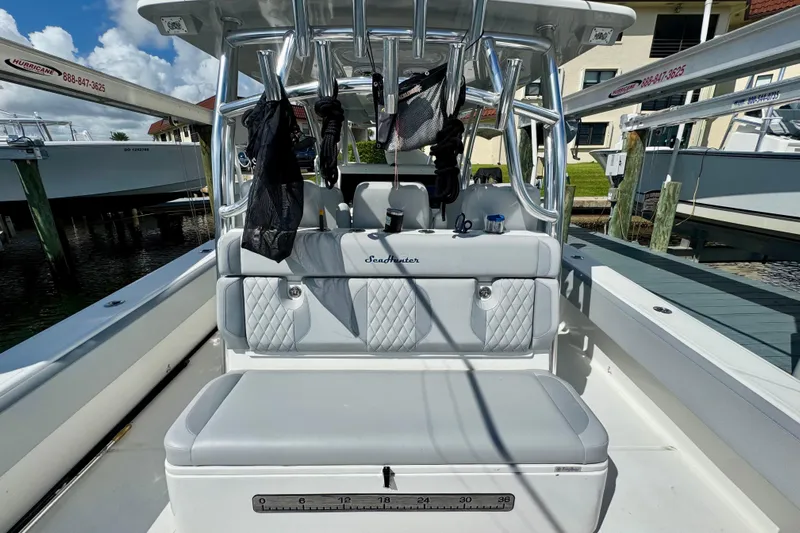 Trade In-- Bring All Offers & Trades Yacht Photos Pics 2021 SeaHunter 41 CTS boat interior with cushioned seating and rod holders.