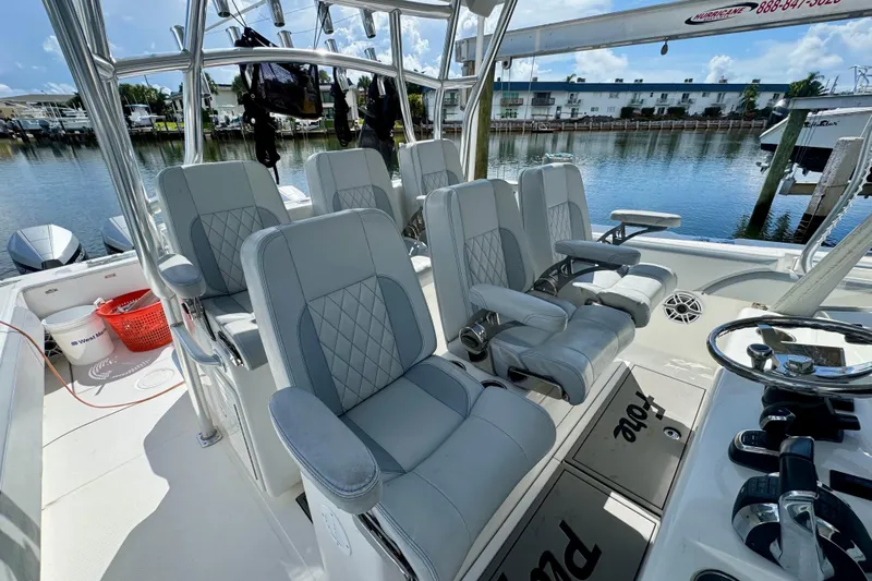 Trade In-- Bring All Offers & Trades Yacht Photos Pics 2021 SeaHunter 41 CTS boat interior with luxurious seating and modern controls, docked by the water.