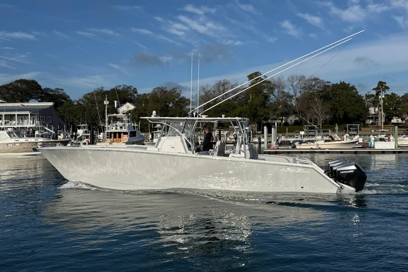 Trade In-- Bring All Offers & Trades Yacht Photos Pics 2021 SeaHunter 41 CTS boat cruising on calm water near a marina.