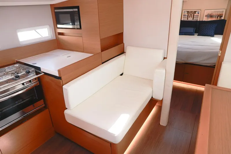 Espiritu Milagro Yacht Photos Pics Interior of 2022 Jeanneau Sun Odyssey 410 yacht with modern kitchen and cozy seating.