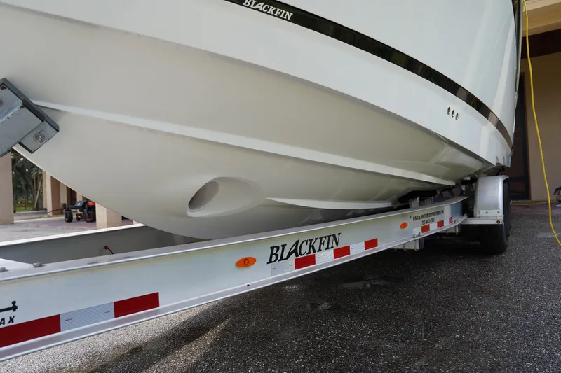  Yacht Photos Pics 2023 Blackfin 302 CC boat on trailer, showcasing sleek hull design.