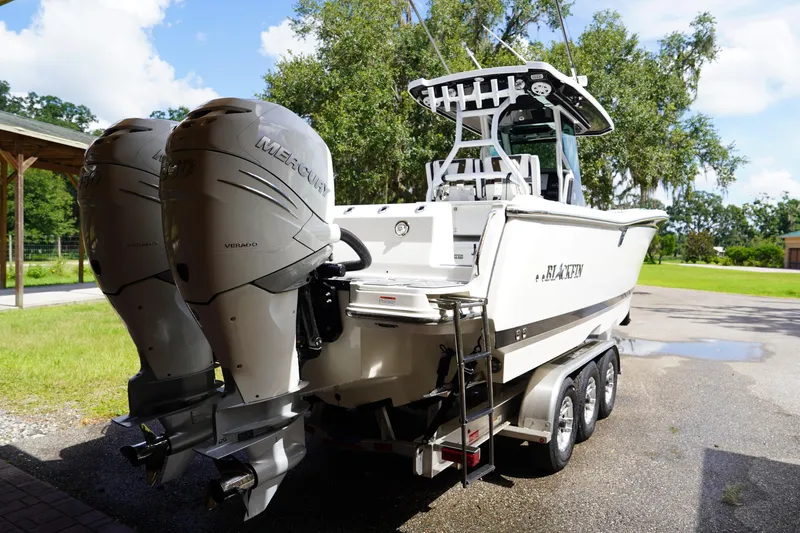  Yacht Photos Pics 2023 Blackfin 302 CC boat with dual Mercury engines on a trailer.