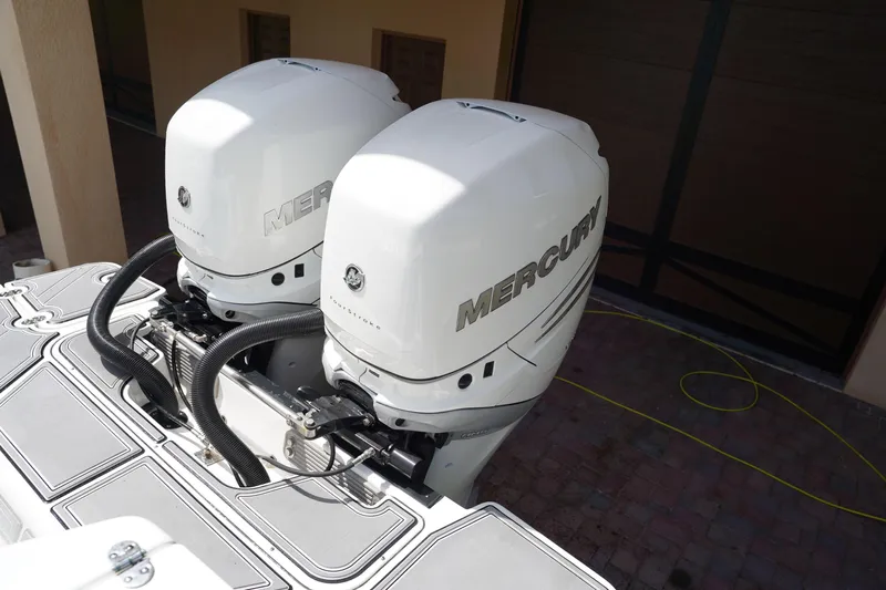  Yacht Photos Pics 2023 Blackfin 302 CC with dual Mercury outboard engines, parked on a brick driveway.