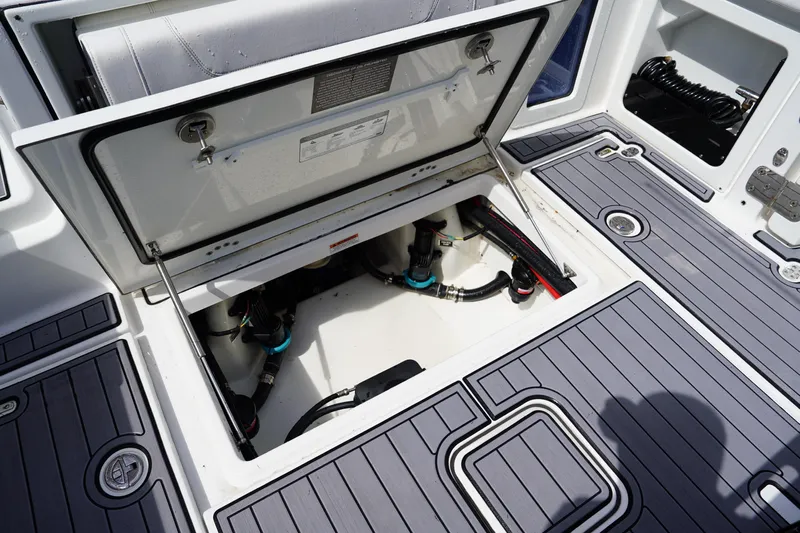  Yacht Photos Pics 2023 Blackfin 302 CC boat deck with open storage compartment and visible wiring.