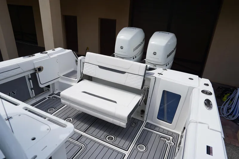  Yacht Photos Pics 2023 Blackfin 302 CC boat interior with foldable seating and dual Mercury engines.