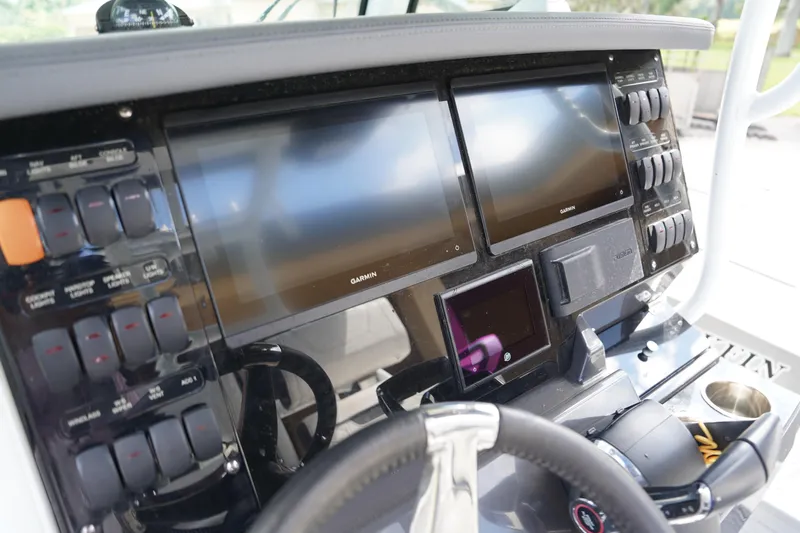  Yacht Photos Pics 2023 Blackfin 302 CC boat dashboard with Garmin displays and control panel.