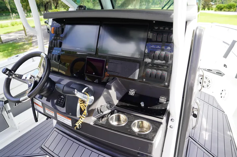  Yacht Photos Pics 2023 Blackfin 302 CC boat dashboard with steering wheel and electronic controls.