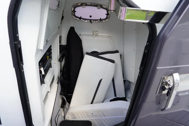  Yacht Photos Pics Interior cabin of 2023 Blackfin 302 CC boat, featuring seating and control panel.