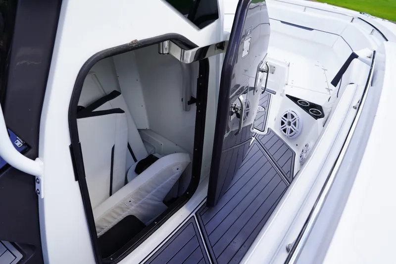  Yacht Photos Pics 2023 Blackfin 302 CC boat interior with open cabin door and seating area.