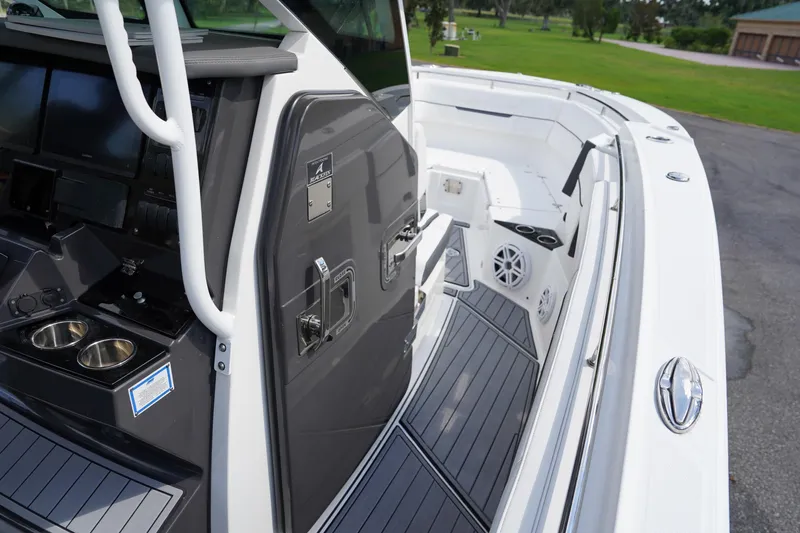  Yacht Photos Pics 2023 Blackfin 302 CC boat interior with modern dashboard and seating area.