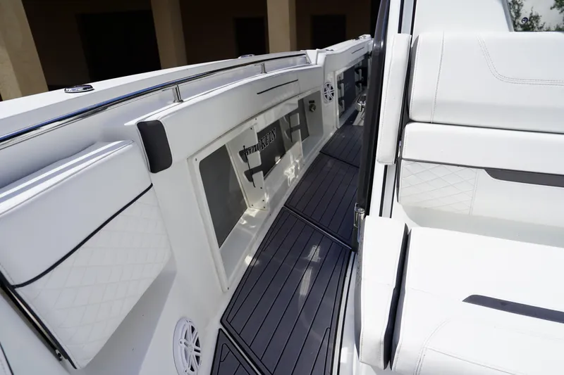  Yacht Photos Pics 2023 Blackfin 302 CC boat interior with sleek white seating and modern design.